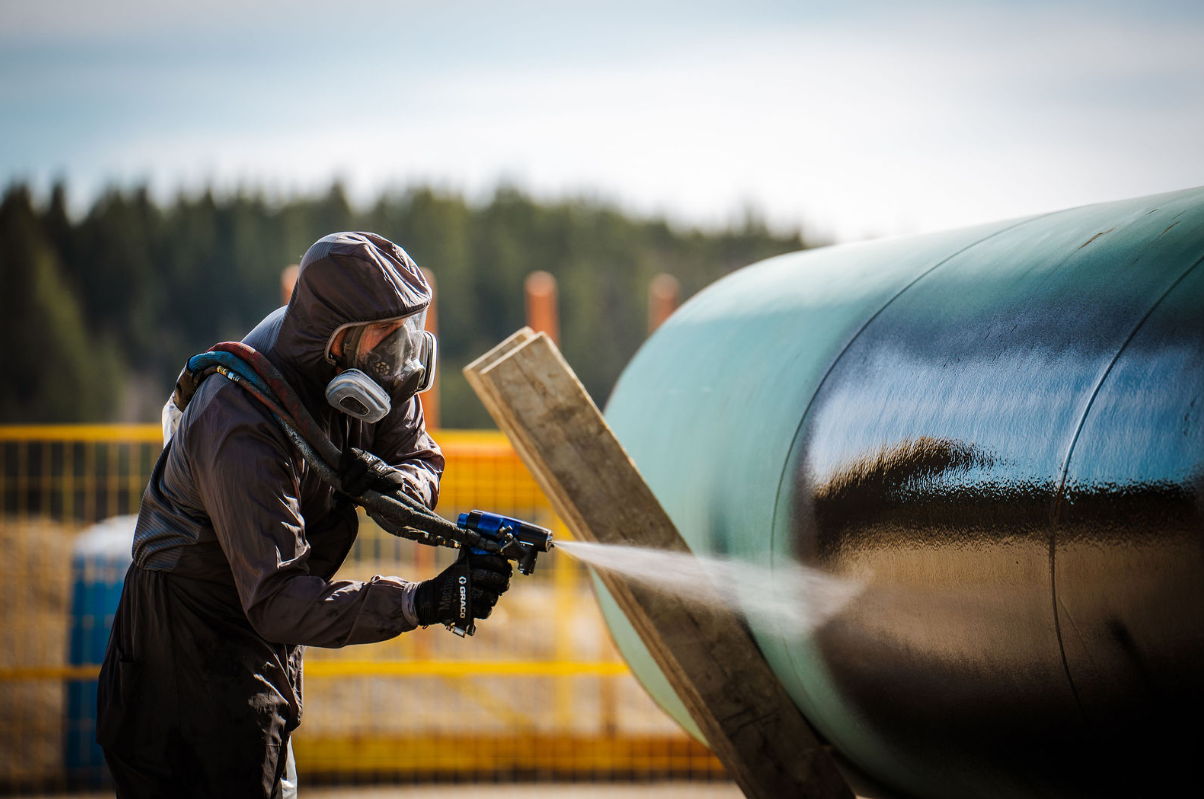 Tennexor polyurea spray coating being applied to oil and gas pipeline